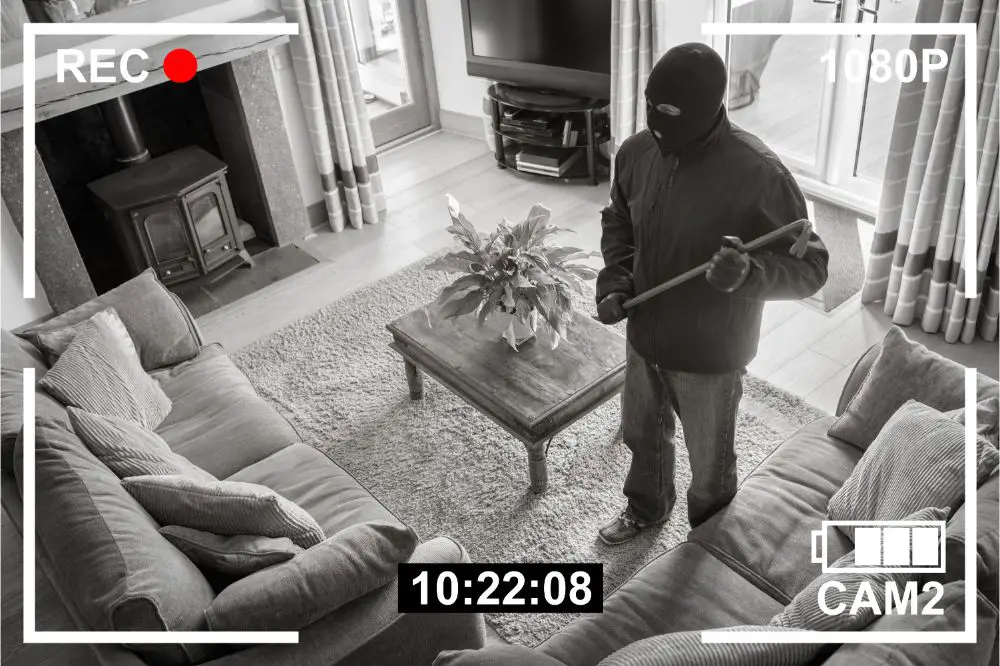 CCTV surveillance security camera of burglar breaking into home