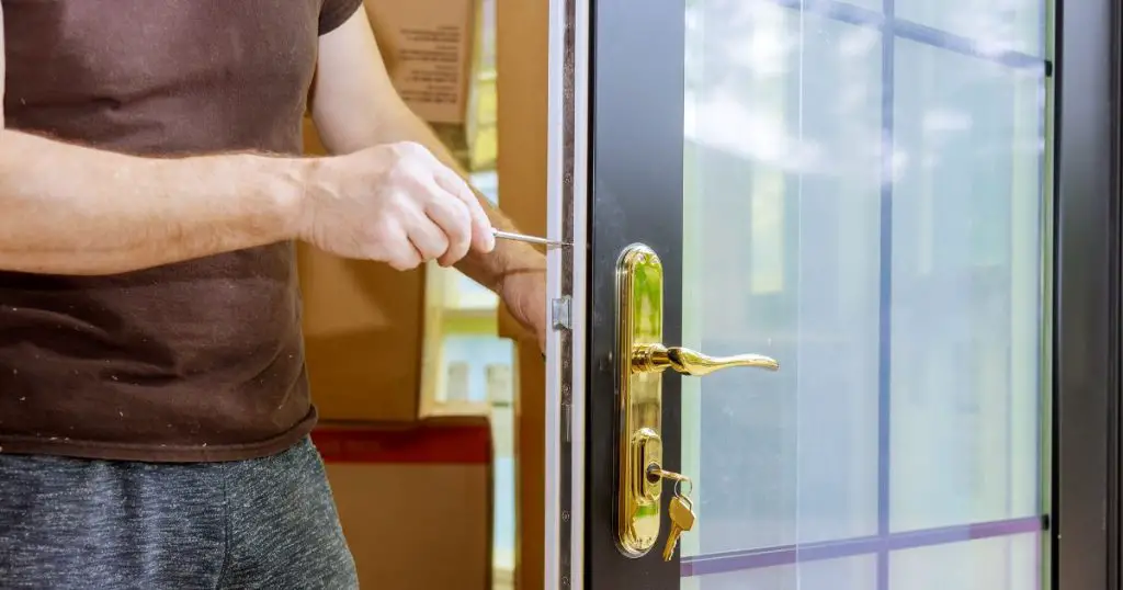 man installing security lock on french doors