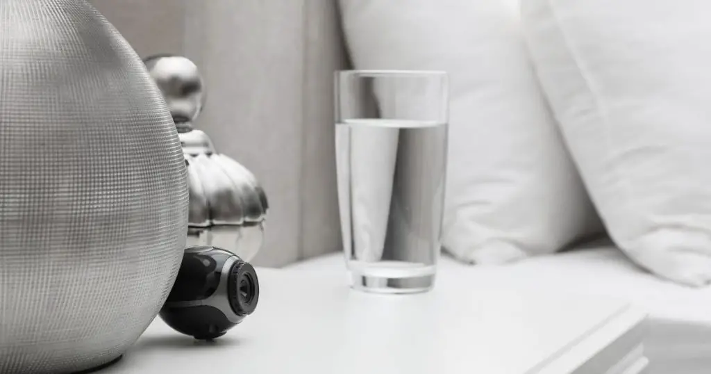 Small Hidden Camera on White Nightstand in Bedroom