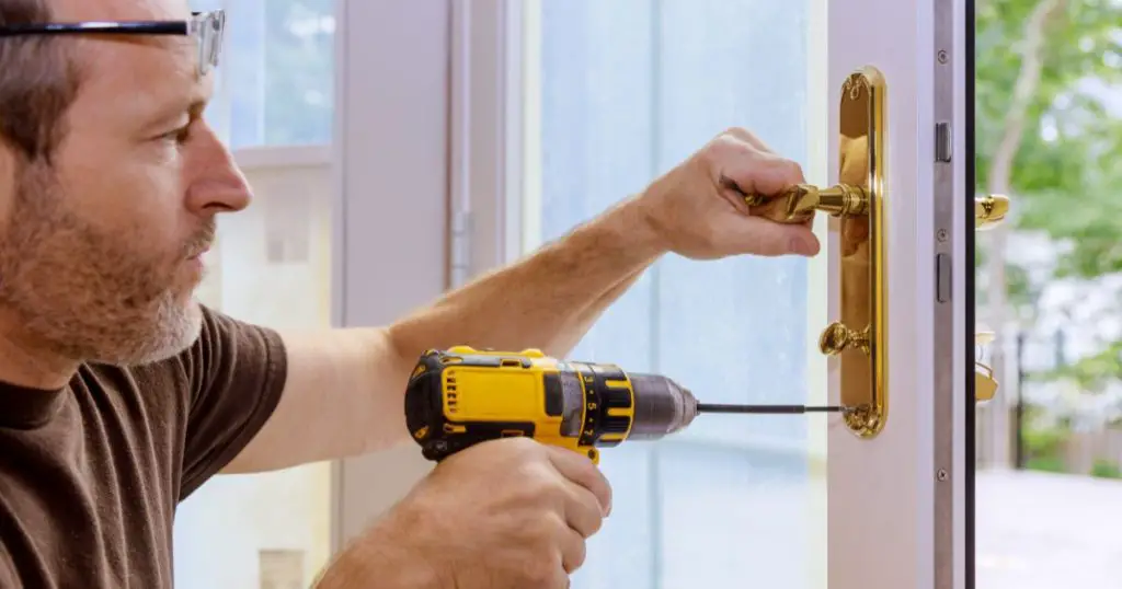 professional locksmith repairing a new deadbolt lock