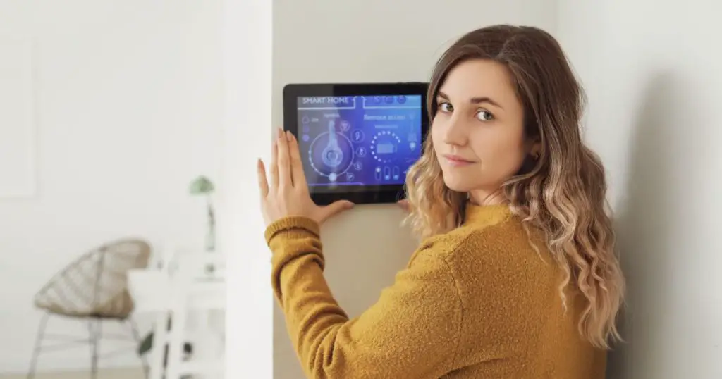 woman using smart home security system control panel